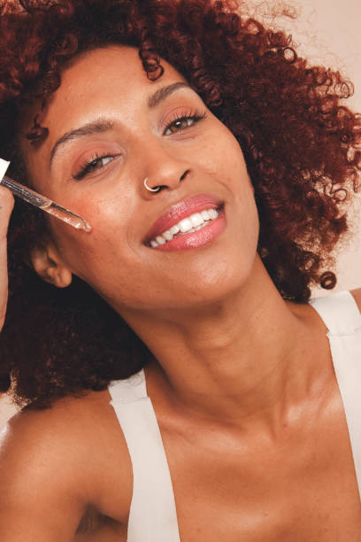 istock Beautiful woman applying serum on her face 2160229169