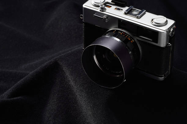 istock Old film camera isolated on dark background 2160229718