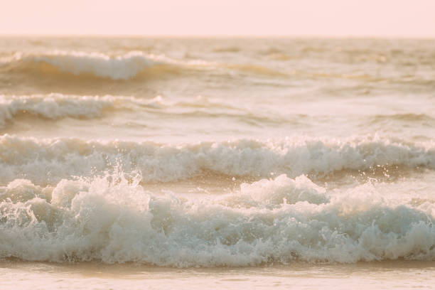 At the beach with splashing water contrasting with sunlight.