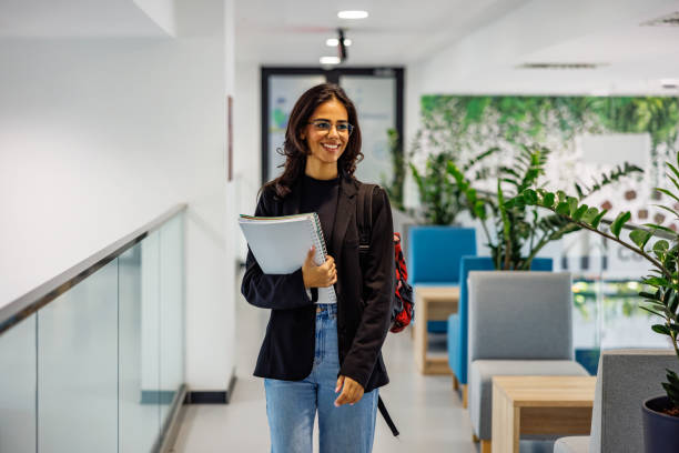 istock Beautiful young lady walking in university 2160234666