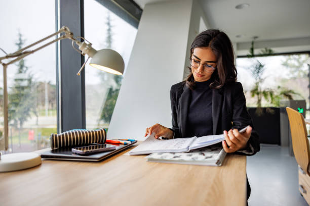 Beautiful woman examines documents in office