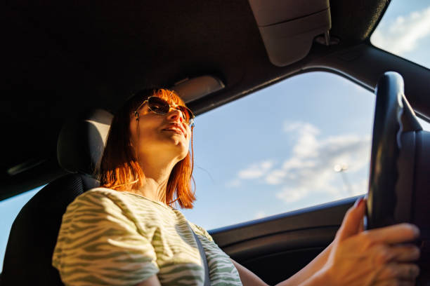 istock Happy woman driving home from work 2160234855