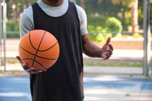 istock Unrecognizable basketball player holding ball and explaining tactics on court 2160237600