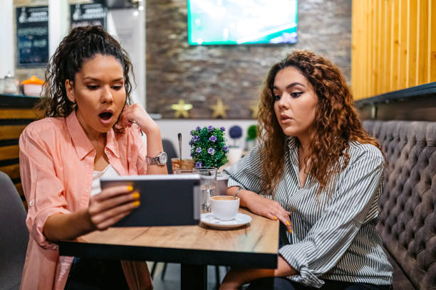 istock Two Female Friends Being Surprised By Something On The Digital Tablet While Drinking Coffee In A Café 2160238672