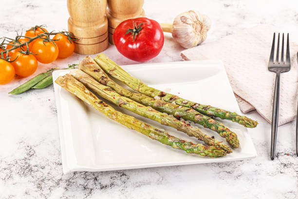 istock Grilled asparagus sprouts served red pepper 2160239451
