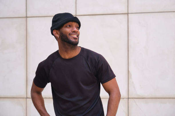 istock Young urban man wearing black beanie smiling and posing 2160239457