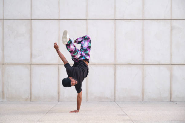 istock Young man is practicing breakdance moves in the street 2160240092