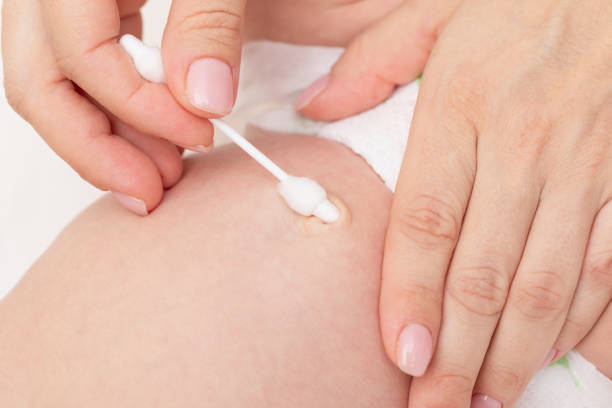 istock Mother Cleaning Newborn Babys Navel 2160243144