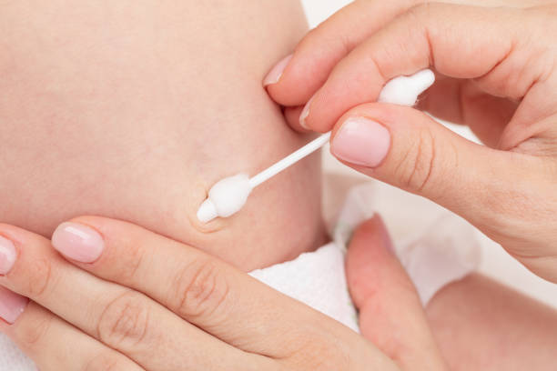 istock Mother Cleaning Newborn Babys Navel 2160243182