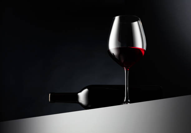 istock Glass and bottle of red wine on a dark background. 2160244723