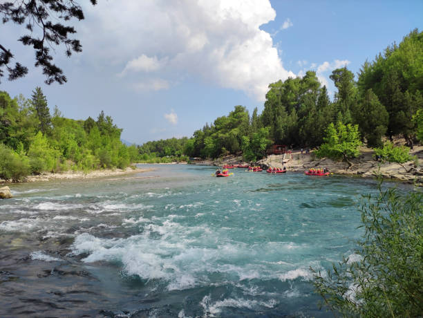 istock Rafting on a mountain river, with many people in vests and with oars, on inflatable rafting boats, in a picturesque forest place 2160245057