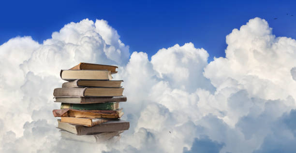 istock A Stack of Books Floating Among Puffy White Clouds in a Bright Blue Sky 2160245192