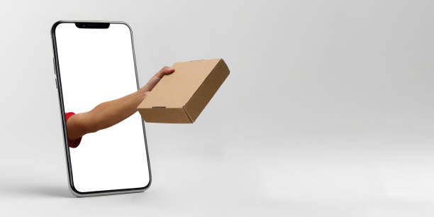 istock Delivery Service Concept: Hand Holding Brown Paper Box Package 2160246811