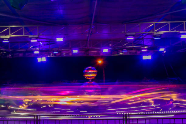 Motion blur image of a spinning amusement ride at a travelling fairground in the North East of England.