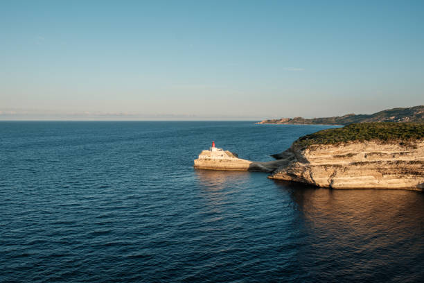 Early morning sun on Phare de la Madonetta, a lighthouse on a limestone promontory at the entrance to the harbour at Bonifacio in Corsica