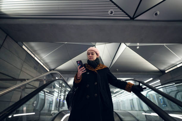 Woman using her smartphone in the subway
