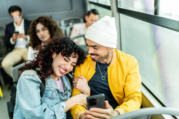 istock Friends using mobile phone on the bus 2160253005