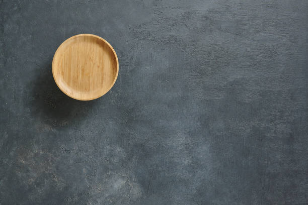istock Wood plate on the textured background table style. 2160254824