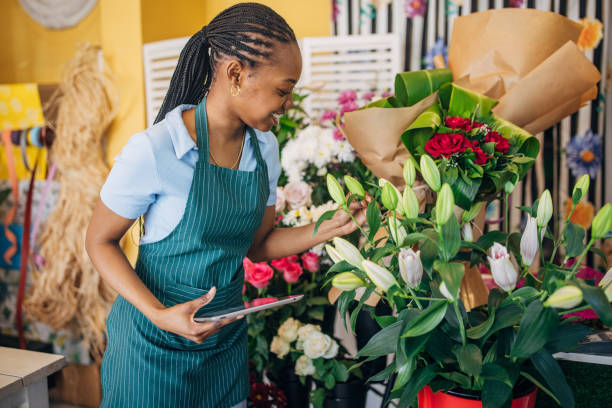 istock Florist examining various colorful flower bouquets. 2160255045