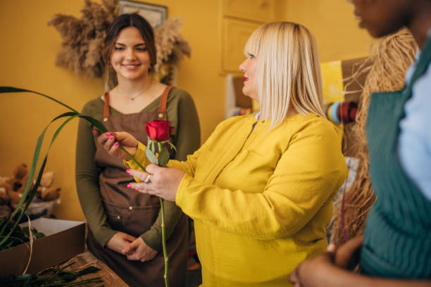 istock Florist guiding students in vibrant flower arranging class 2160255264