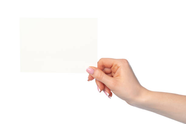 istock Woman's hand holding blank white sheet of paper isolated on white 2160256228