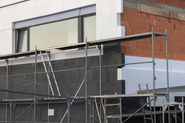 istock insulating the walls with modern thermal insulation materials. The new house construction process involves Exterior covering is applied at the construction site. 2160256239