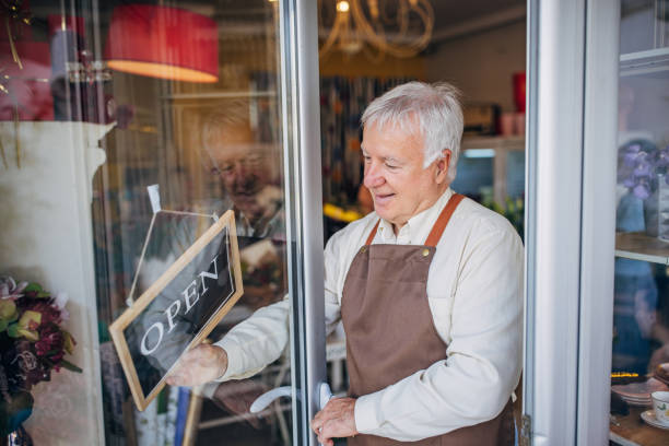 istock Florist opening flower shop for customers, arms folded. 2160257629