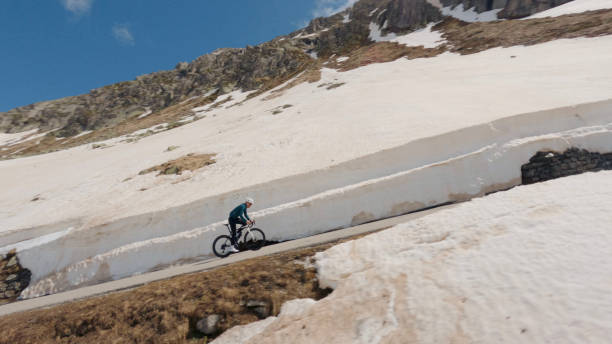 istock Road biker rides up high mountain pass 2160261547