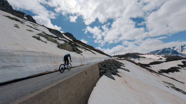istock Road biker rides up high mountain pass 2160261553