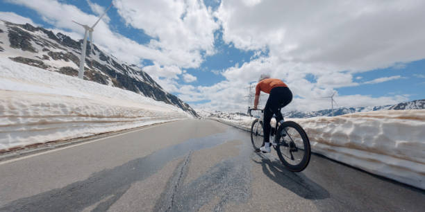istock Road biker rides up high mountain pass 2160261580