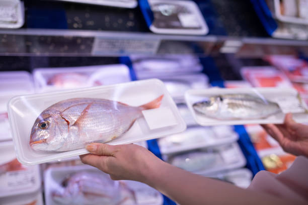 Woman's hand choosing fish