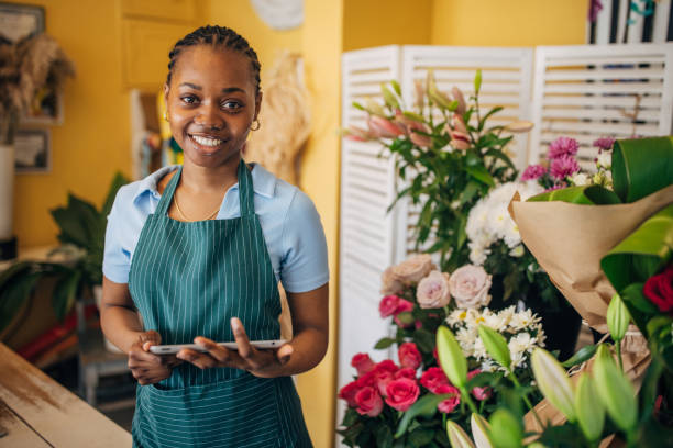 istock Florist with tablet in cozy flower shop 2160261942
