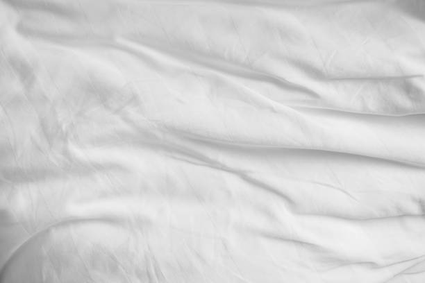 Abstract White Bedding Sheets or White wrinkled fabric background texture and Texture with copy-space :Creased or wrinkled white fabric,Soft focus