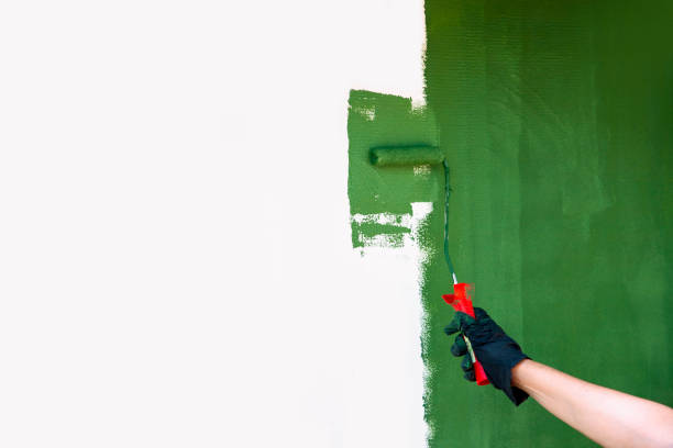 istock Painting with Green Paint using small roller on the wall 2160262499