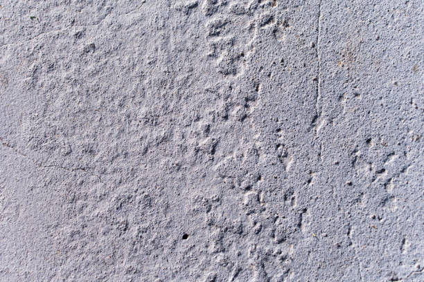 istock Texture of a rough, cracked and somewhat dirty cement wall. 2160263794