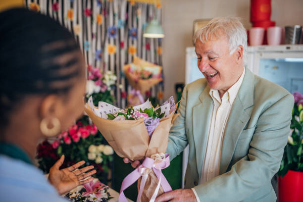 istock Content customer smiling with flowers in hand, happy. 2160264543