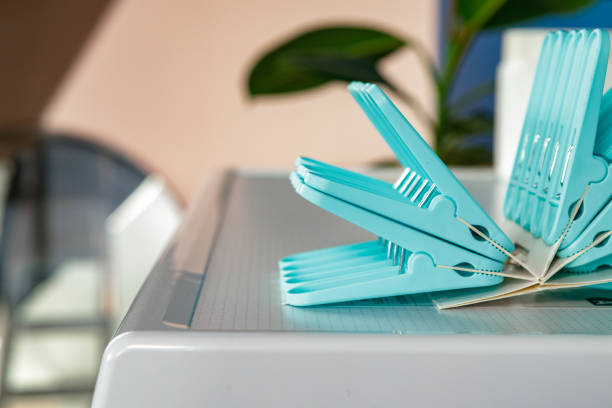 istock Blue clothes pins on white washing machine 2160265260