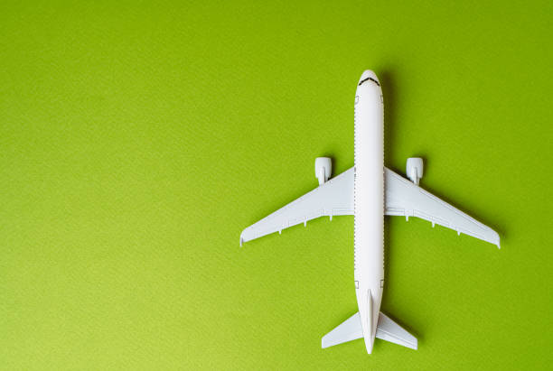 Passenger plane on a green background and space for text. Environmentally friendly fuel. Technological innovations in aviation industry. Green air transportation