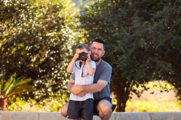 istock Father's Day: Father Teaching Son Photography 2160268280