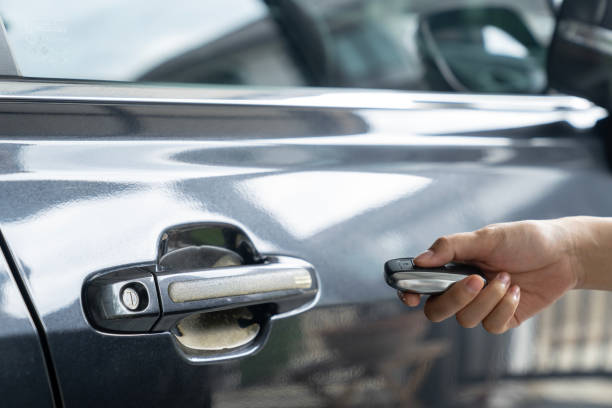 istock Hand holding keyless car and opening the door 2160268501