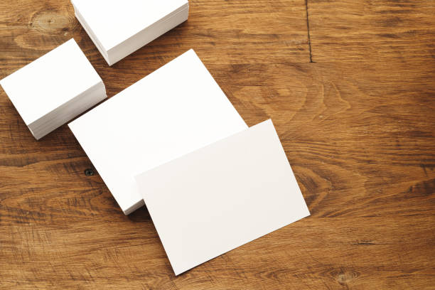istock Blank businesscard stacks on rough wooden table 2160268531