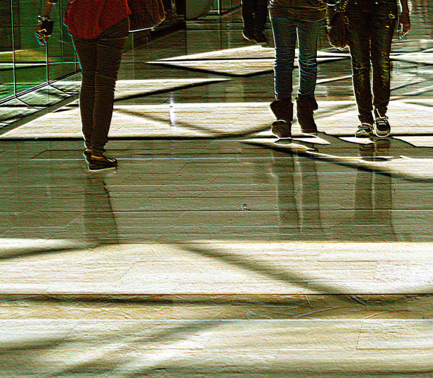 Westfield Shopping Mall, Shepherds Bush, London, May 2011\n\nThe sun shining through the glass roof of the famous Westfield Shopping Mall, in West London.  The strong sunlight has created lovely shadows on the shop floor.\n\nTo create a better atmosphere in the image the people walking by have been cropped off at the waist, to concentrate on their shoes and clothing, which have been enhanced in Adobe Photoshop so the lush colors of the clothes and shoes stand out more.