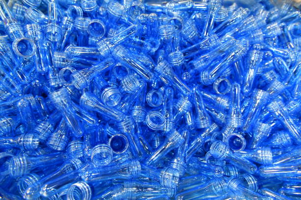istock Stack of Blue Plastic bottles in production line at manufacturing PET perform, before bottles blowing in blowing machine at drink water factory. 2160271890