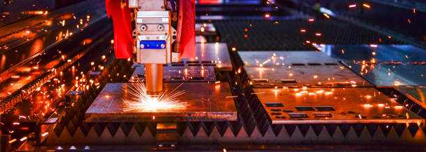 Industrial laser cut machine while cutting the sheet metal with the sparking light.