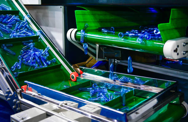 Blue Plastic bottles in production line at manufacturing PET perform, before bottles blowing in blowing machine at drink water factory.