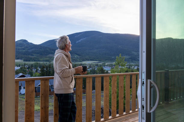 istock Senior man relaxes on verandah with hot beverage 2160274223