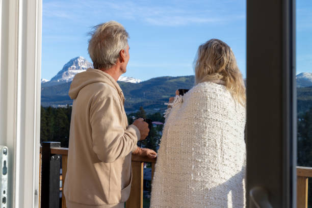 istock Senior couple relax on verandah with hot beverage 2160274811