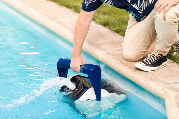istock Man taking robot out of pool 2160275550