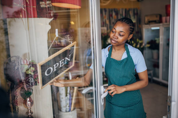 istock Focused florist opening a flower shop 2160275601