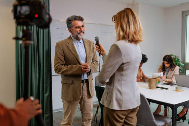 istock Businessman giving interview for TV 2160276503